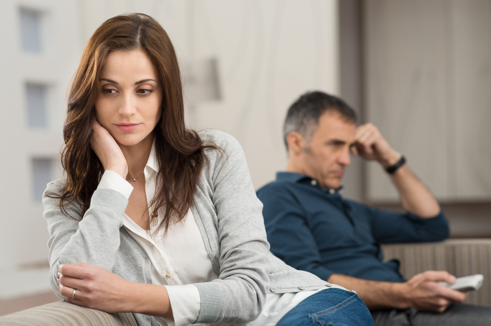 Upset couple on couch facing away from each other