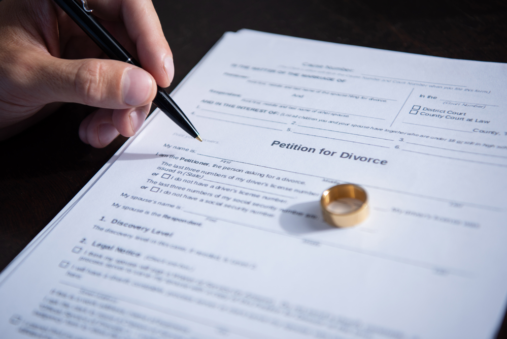 Wedding ring on top of divorce documents