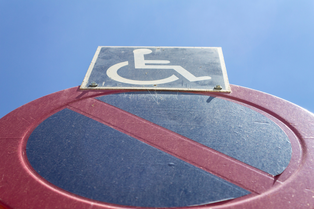 Low angle photo of handicapped no parking sign