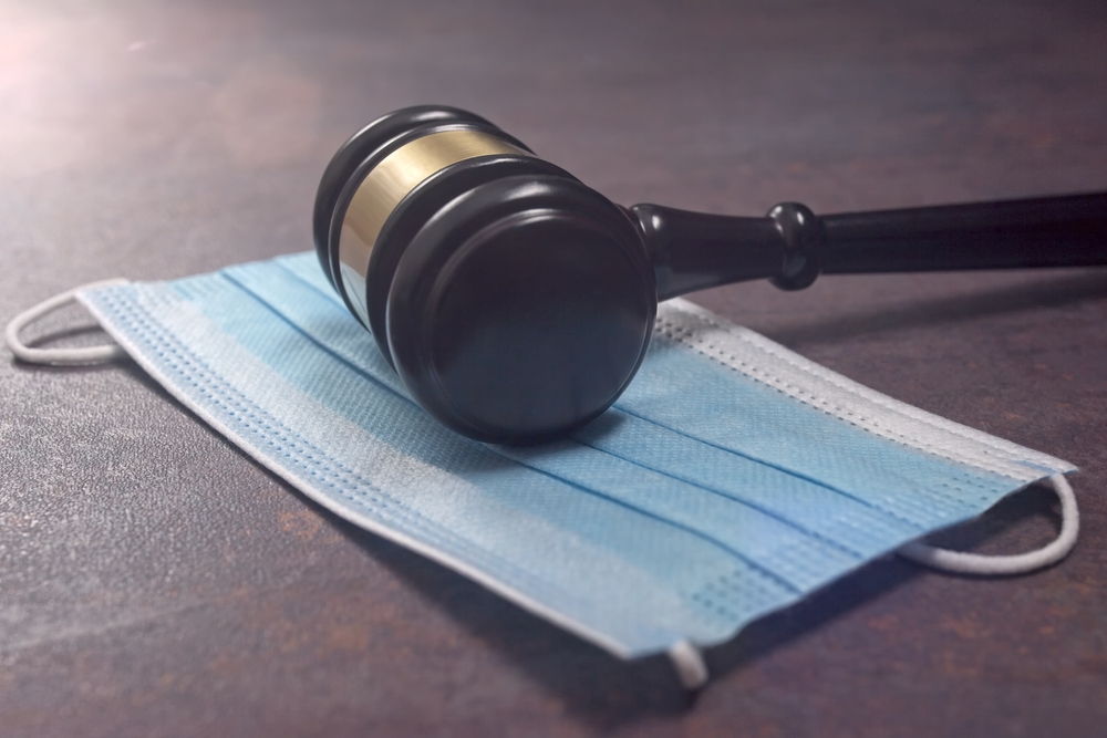 Gavel and facemask on desk