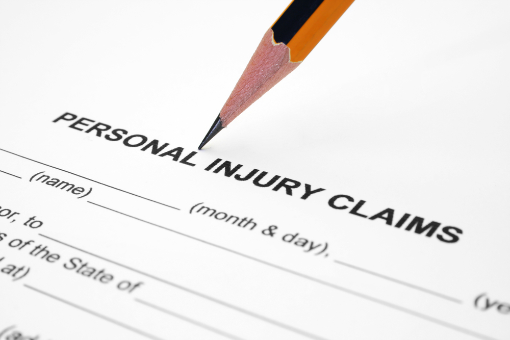 Pencil resting on Personal Injury Claims form