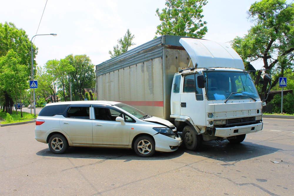 Mini van in a collision with a large delivery truck
