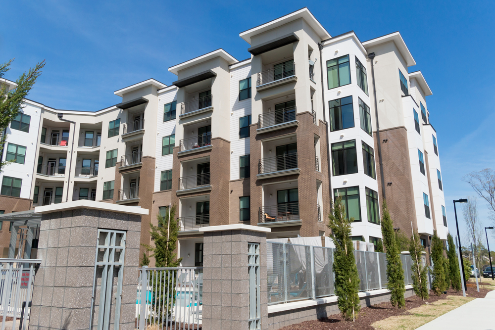 Apartment complex building with fenced pool