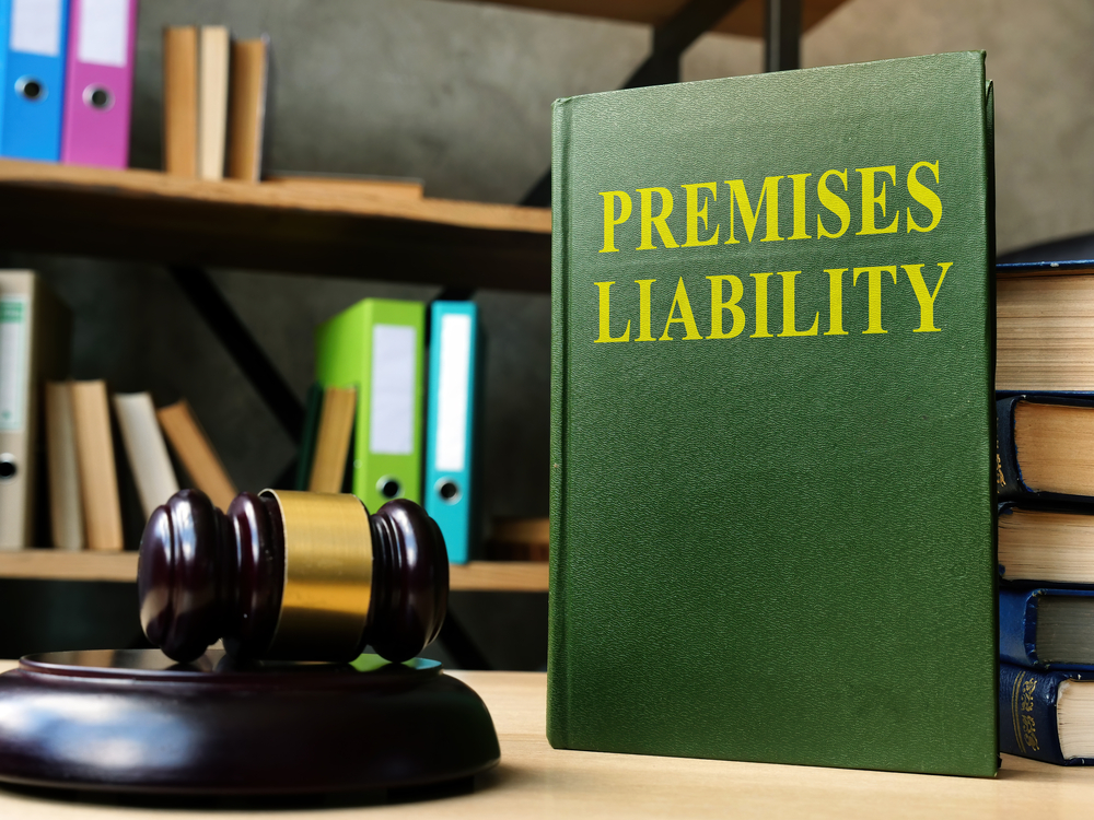Premises liability law book standing up next to judge gavel