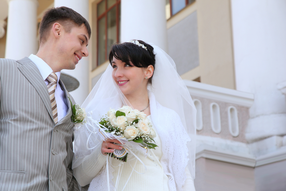 Bride and groom smiling at each other