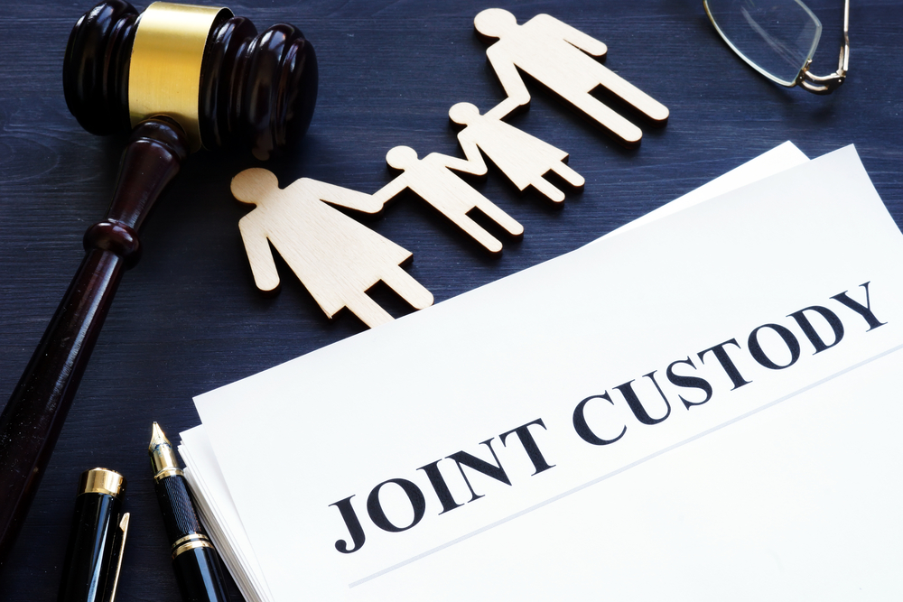 Joint custody documents with paper cutout family