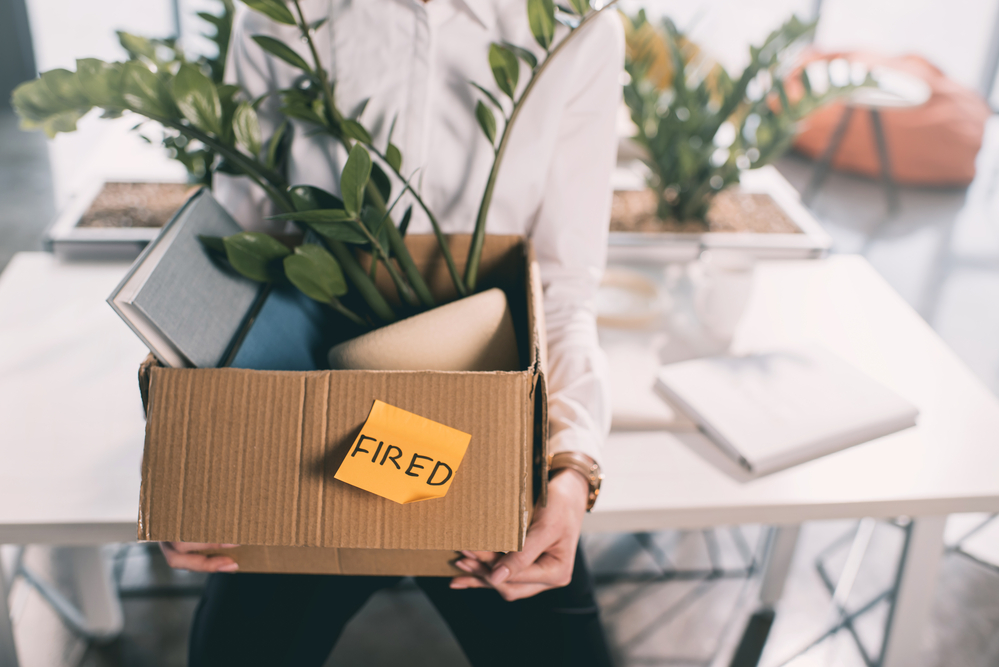 Fired employee with box of possessions