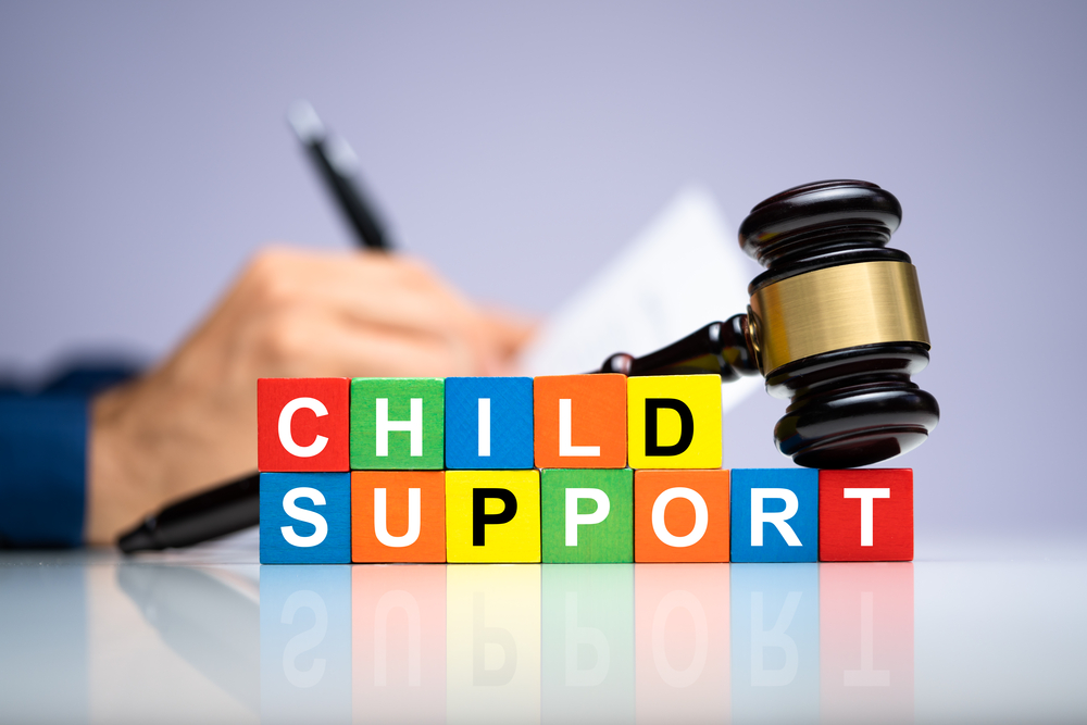 Child support written in colorful blocks with judge's gavel on top