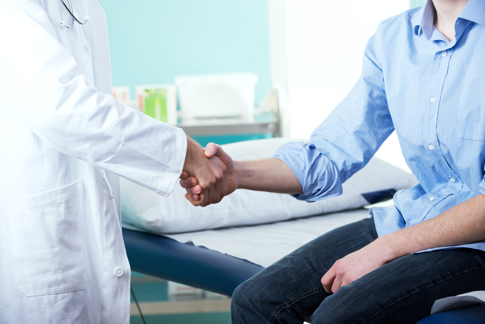 Close up of patient and doctor shaking hands