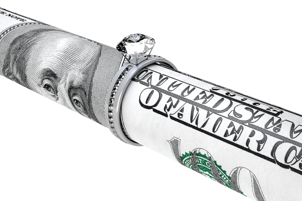 Hundred dollar bill rolled up in diamond ring