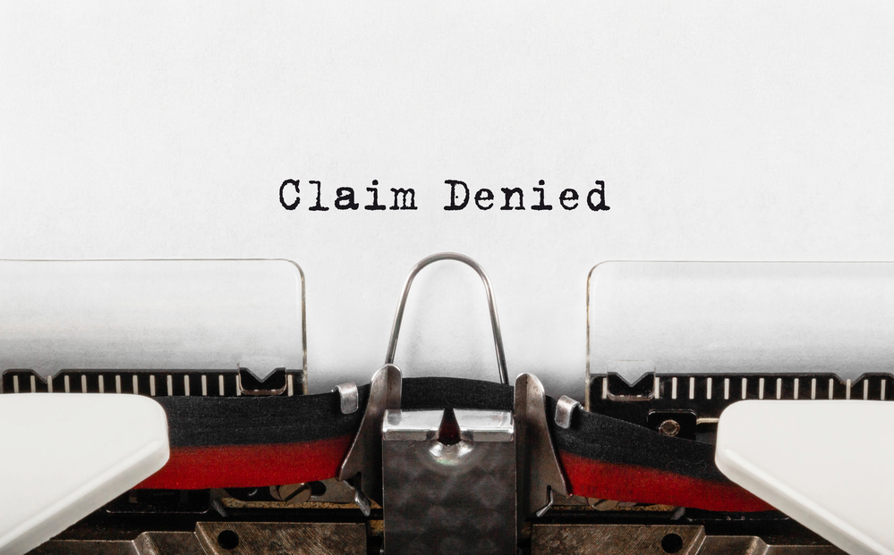 "Claim denied" written on paper with typewriter
