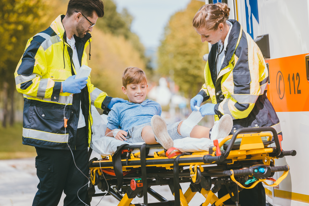 EMTs treating boy on stretcher