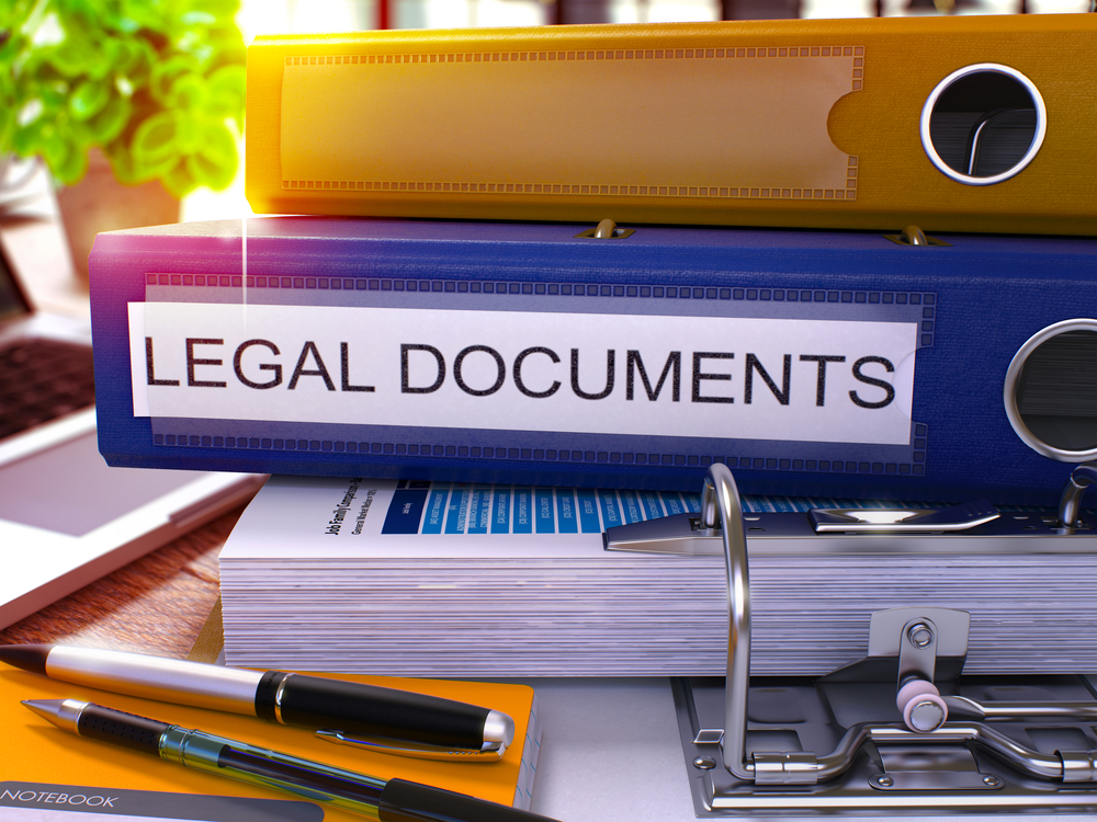 Stack of binders with one labeled as Legal Documents