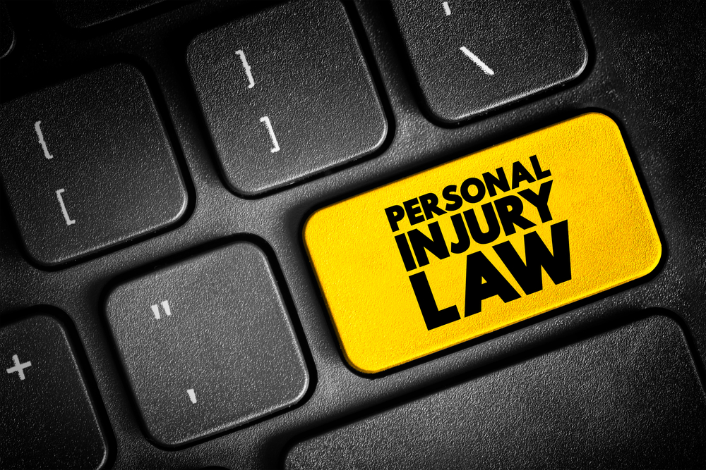 Yellow personal injury law button on black keyboard