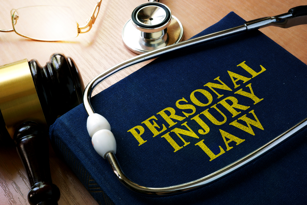 Personal injury law book with stethoscope and gavel