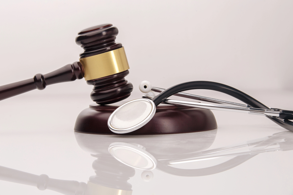 Stethoscope and gavel on table