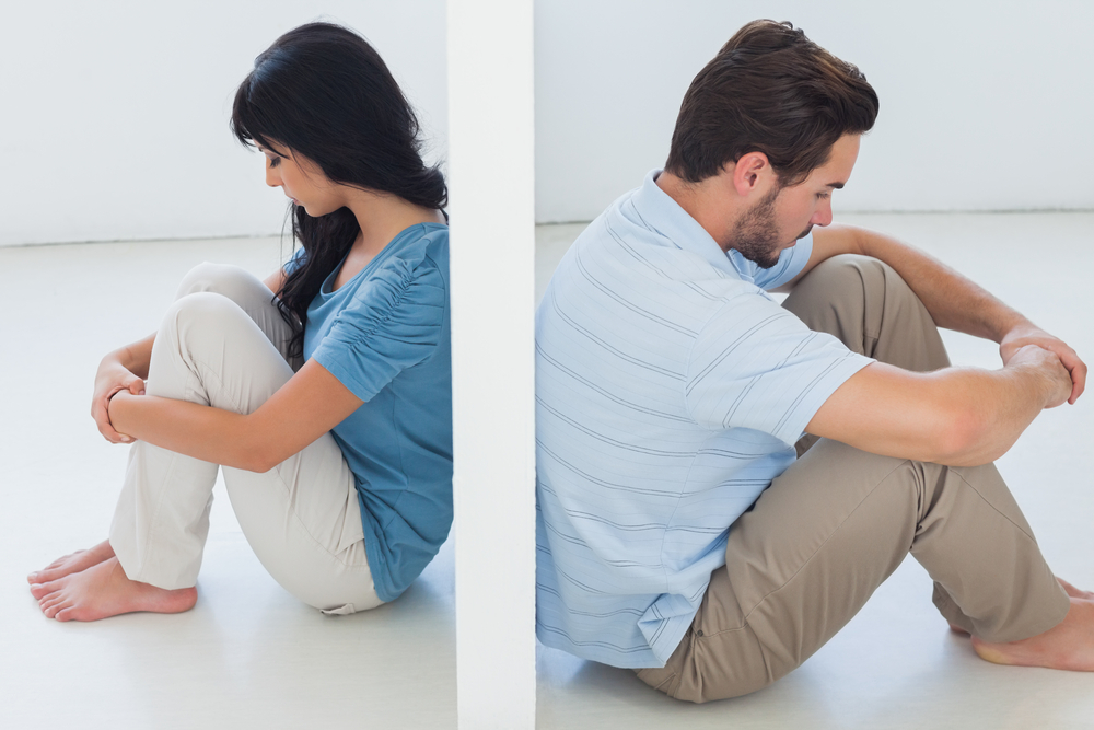 Couple separated by white wall