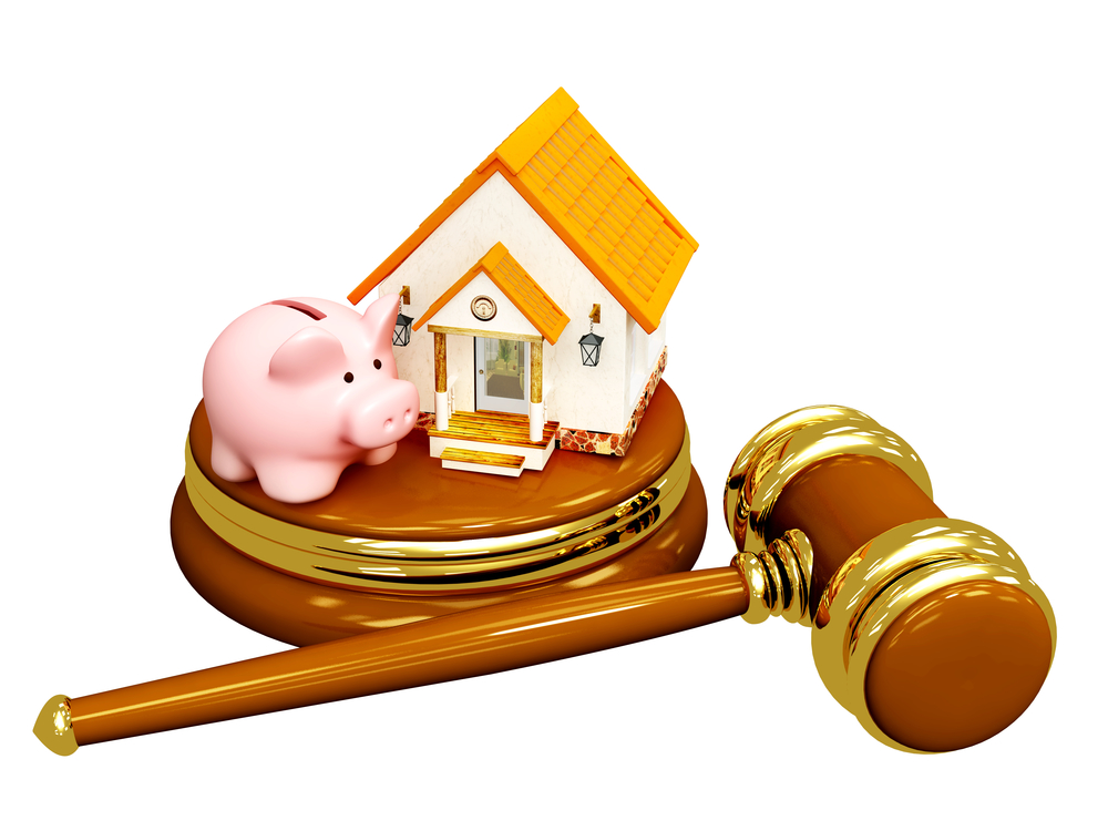 Piggy bank and house with judge's gavel