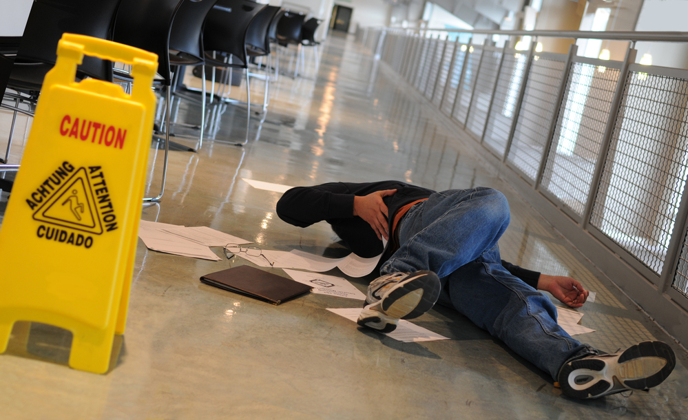 Fallen man near wet floor sign