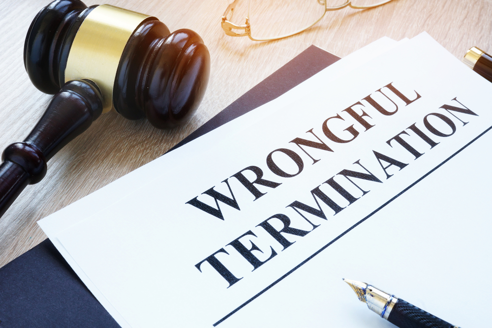 Gavel with wrongful termination paperwork
