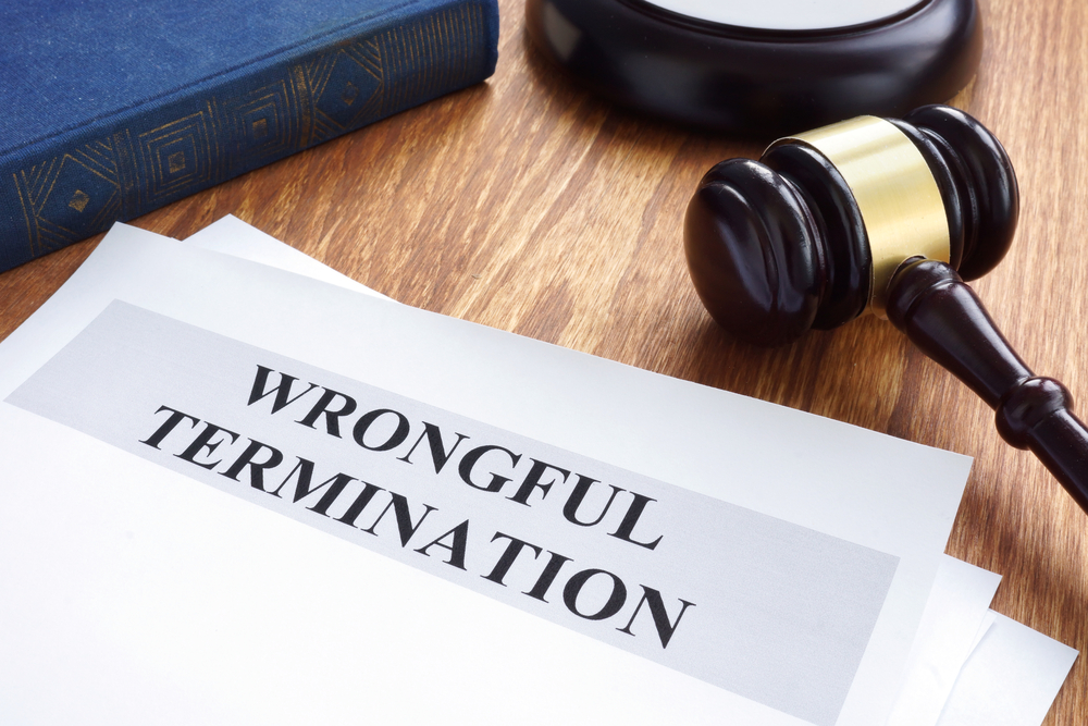 Wrongful termination paperwork on desk next to gavel